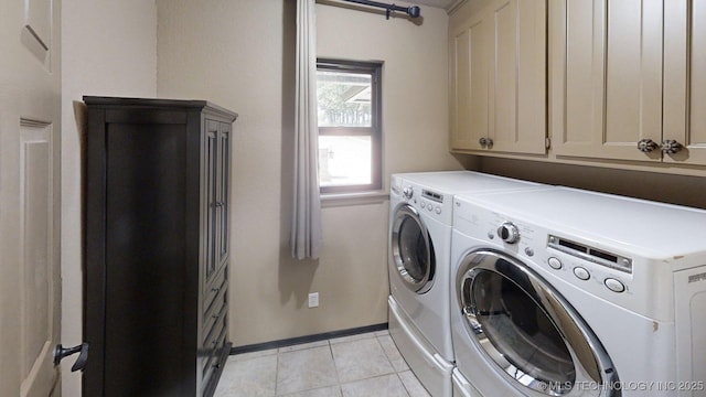 6166 Hedges St, Ardmore, OK 73401 - laundry area with washing machine and dryer, light tile patterned floors, and cabinet space