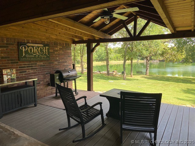 6166 Hedges St, Ardmore, OK 73401 - wooden terrace with a water view, a ceiling fan, a yard, and grilling area