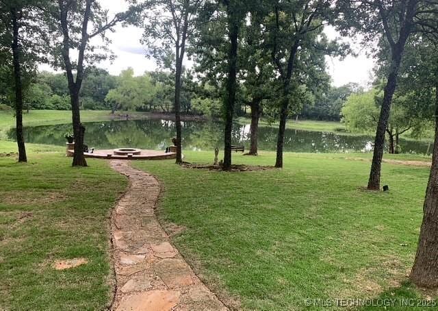 6166 Hedges St, Ardmore, OK 73401 - view of community featuring a water view, a lawn, and an outdoor fire pit