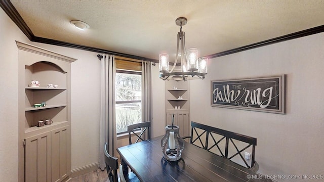 6166 Hedges St, Ardmore, OK 73401 - dining area with crown molding, a chandelier, wood finished floors, a textured ceiling, and built in shelves