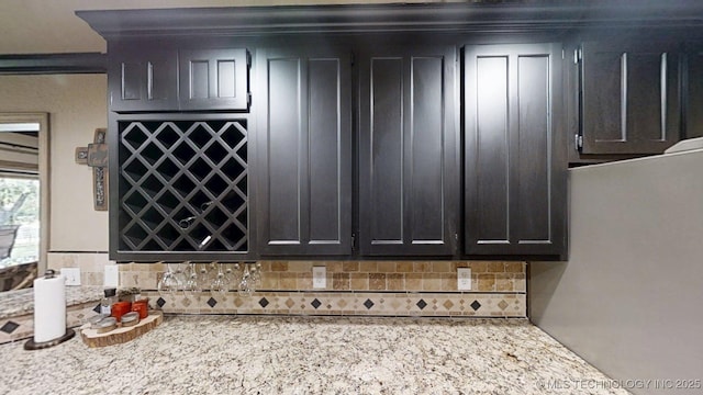 6166 Hedges St, Ardmore, OK 73401 - kitchen featuring backsplash, refrigerator, and dark cabinets