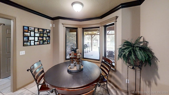 6166 Hedges St, Ardmore, OK 73401 - dining room with crown molding, a textured ceiling, and light tile patterned floors