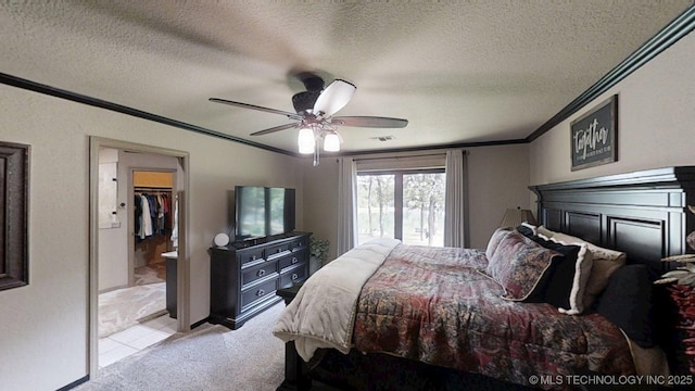 6166 Hedges St, Ardmore, OK 73401 - bedroom with ornamental molding, light carpet, a walk in closet, ceiling fan, and a textured ceiling