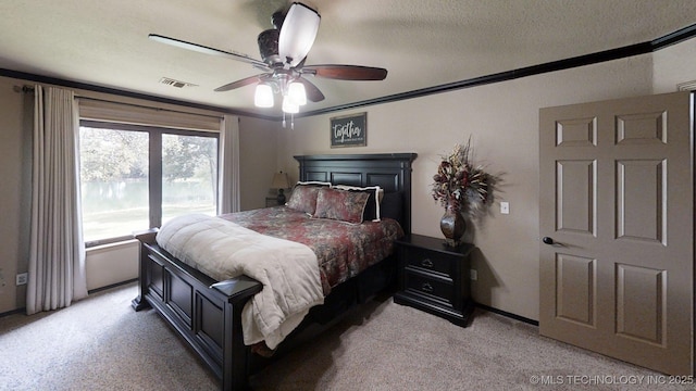 6166 Hedges St, Ardmore, OK 73401 - bedroom with light carpet, ceiling fan, and crown molding