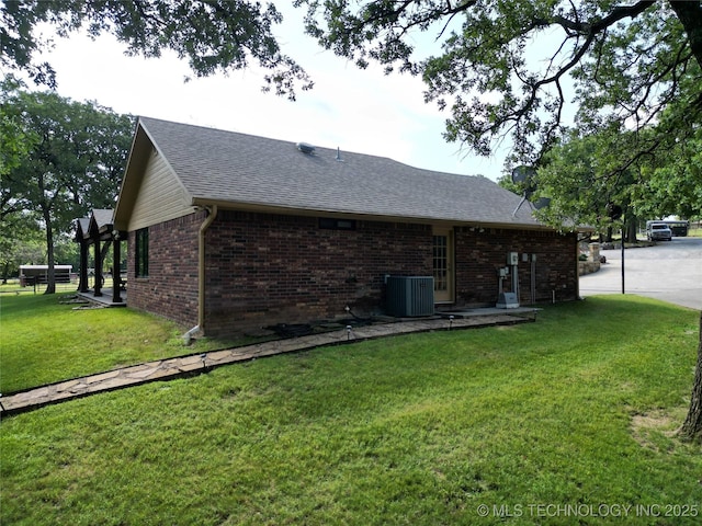 6166 Hedges St, Ardmore, OK 73401 - view of side of home featuring a shingled roof, brick siding, and a lawn