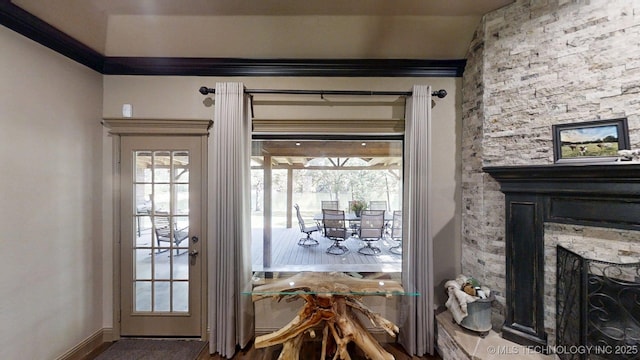 6166 Hedges St, Ardmore, OK 73401 - doorway to outside featuring a stone fireplace and baseboards