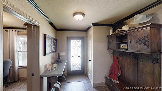 6166 Hedges St, Ardmore, OK 73401 - mudroom with light wood-type flooring, a textured ceiling, and ornamental molding