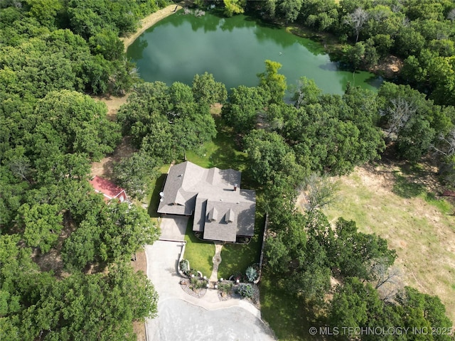 6166 Hedges St, Ardmore, OK 73401 - aerial view of property and surrounding area featuring a nearby body of water and a heavily wooded area