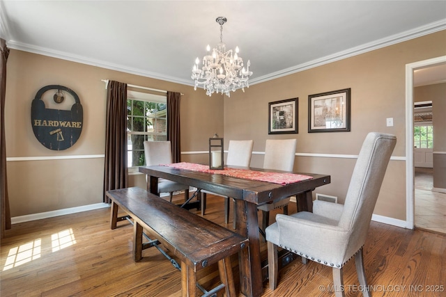 213 Moccasin Ln, Sapulpa, OK 74066 - dining room featuring a chandelier, plenty of natural light, ornamental molding, and wood finished floors