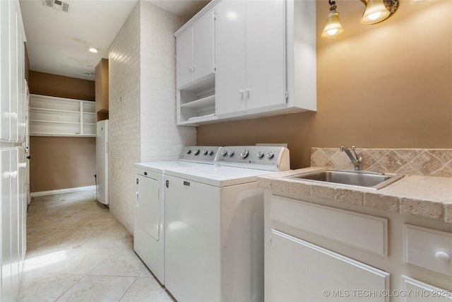 213 Moccasin Ln, Sapulpa, OK 74066 - laundry area featuring washing machine and dryer and cabinet space