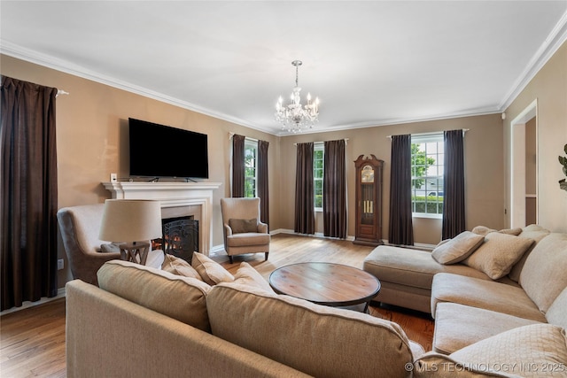 213 Moccasin Ln, Sapulpa, OK 74066 - living area with light wood-style flooring, ornamental molding, a chandelier, and a lit fireplace