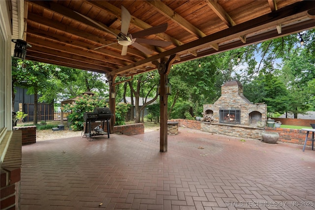213 Moccasin Ln, Sapulpa, OK 74066 - view of patio / terrace with an outdoor stone fireplace and ceiling fan