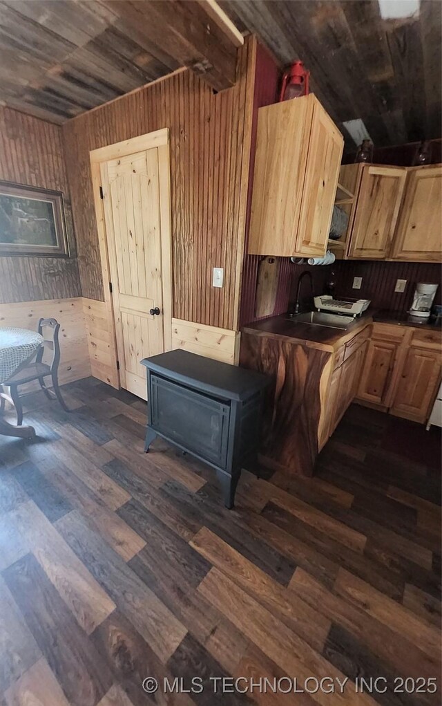 181103 W Sherman Rd, Moyers, OK 74557 - kitchen featuring wooden walls, dark countertops, dark wood finished floors, light brown cabinets, and wood ceiling