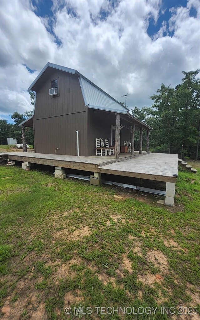 181103 W Sherman Rd, Moyers, OK 74557 - back of property featuring a wooden deck, a yard, and a metal roof