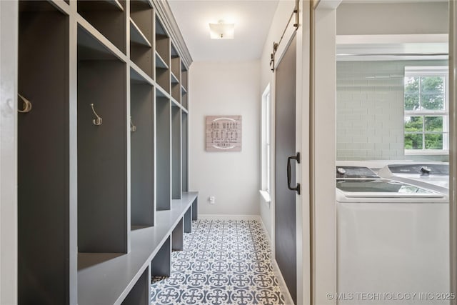 12828 S Mingo Rd, Bixby, OK 74008 - mudroom with a barn door and washer and clothes dryer