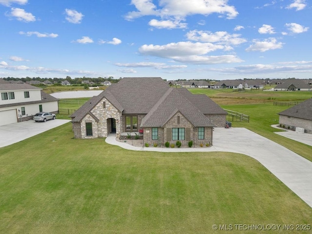 8337 N 149th E Ave, Owasso, OK 74055 - french country home featuring stone siding, a front yard, a residential view, and a shingled roof