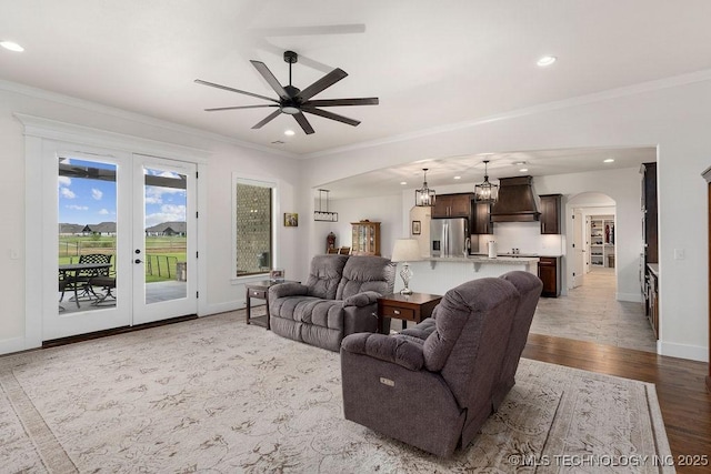 8337 N 149th E Ave, Owasso, OK 74055 - living room with arched walkways, crown molding, ceiling fan, recessed lighting, and a chandelier