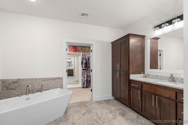 8337 N 149th E Ave, Owasso, OK 74055 - full bath with a soaking tub, vanity, and a walk in closet