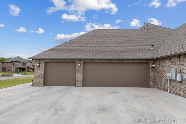 8337 N 149th E Ave, Owasso, OK 74055 - view of side of property with a shingled roof, brick siding, driveway, and an attached garage