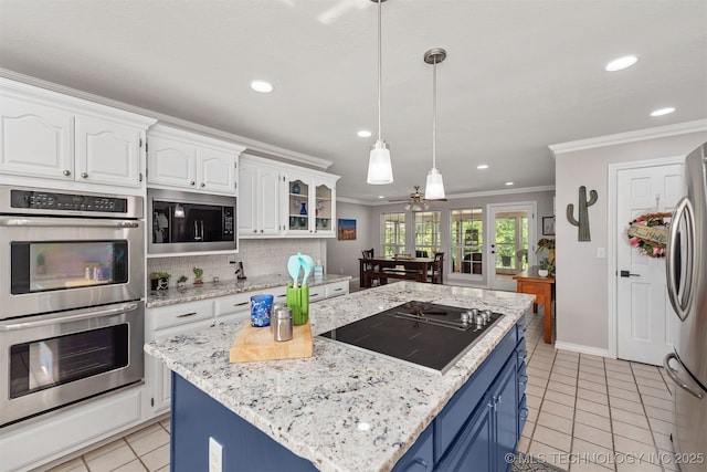 33922 S 4240th Rd, Inola, OK 74036 - kitchen with appliances with stainless steel finishes, blue cabinetry, crown molding, white cabinets, and light tile patterned flooring