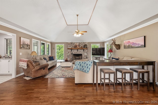 33922 S 4240th Rd, Inola, OK 74036 - living room featuring lofted ceiling, a brick fireplace, a ceiling fan, ornamental molding, and wood finished floors