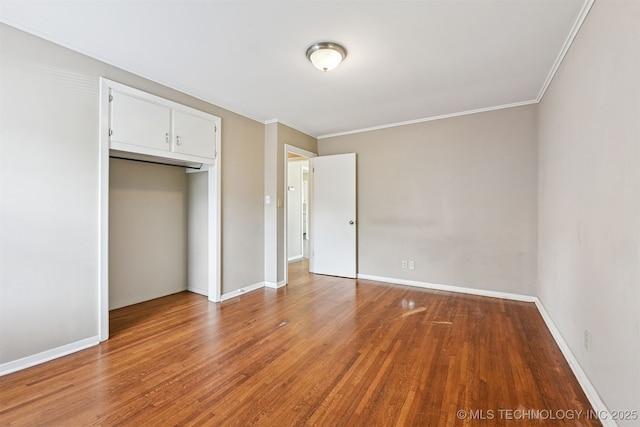 1422 E 52nd St, Tulsa, OK 74105 - unfurnished bedroom featuring wood finished floors, ornamental molding, and a closet