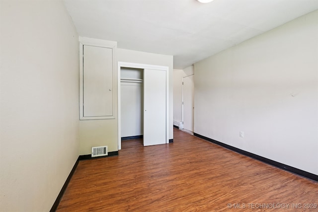 1422 E 52nd St, Tulsa, OK 74105 - unfurnished bedroom featuring wood finished floors and a closet