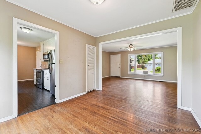 1422 E 52nd St, Tulsa, OK 74105 - spare room featuring wood finished floors, crown molding, and a ceiling fan
