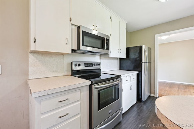 1422 E 52nd St, Tulsa, OK 74105 - kitchen with appliances with stainless steel finishes, dark wood-type flooring, light countertops, tasteful backsplash, and white cabinetry