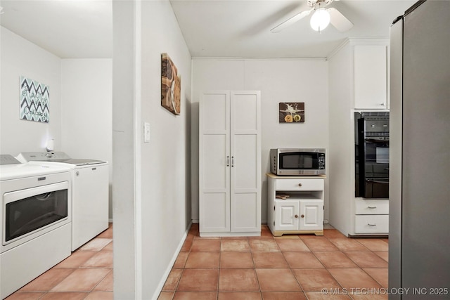 3926 E 51st Pl, Tulsa, OK 74135 - kitchen with stainless steel microwave, separate washer and dryer, black oven, a warming drawer, and ceiling fan