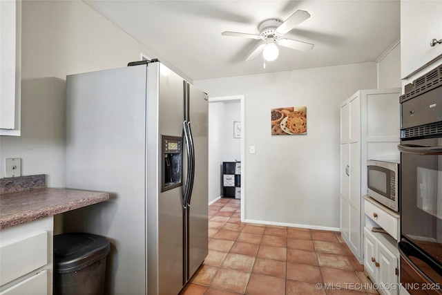 3926 E 51st Pl, Tulsa, OK 74135 - kitchen featuring appliances with stainless steel finishes, a ceiling fan, white cabinetry, light tile patterned floors, and a warming drawer