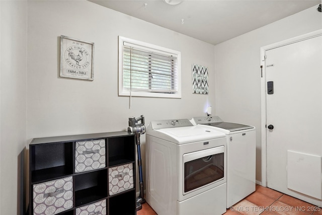 3926 E 51st Pl, Tulsa, OK 74135 - laundry room with washer and clothes dryer and light tile patterned flooring