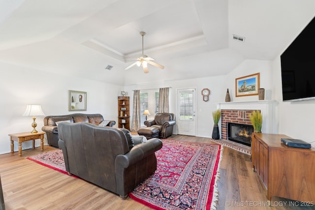 1014 W 120th St S, Jenks, OK 74037 - living area with a fireplace, ceiling fan, light wood-style floors, and a tray ceiling