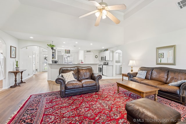 1014 W 120th St S, Jenks, OK 74037 - living room with arched walkways, light wood-style floors, ceiling fan, and recessed lighting
