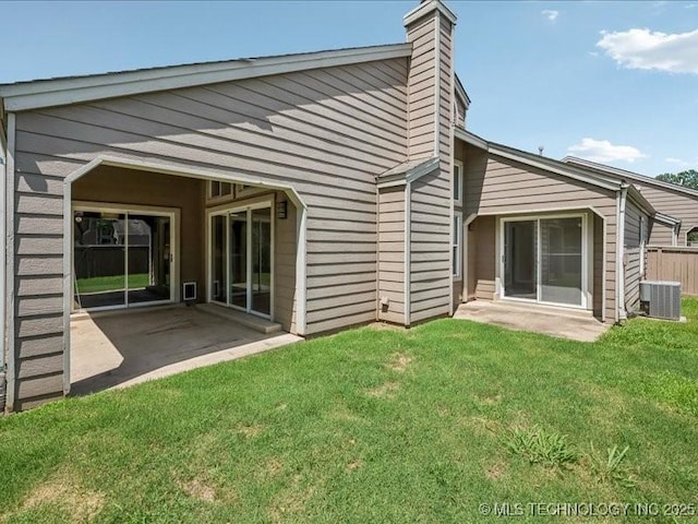 9118 S Florence Ave Unit 9118, Tulsa, OK 74137 - back of property with a patio, a lawn, and a chimney