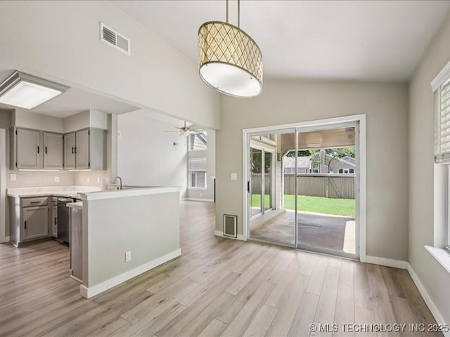 9118 S Florence Ave Unit 9118, Tulsa, OK 74137 - kitchen featuring gray cabinets, light wood-style floors, light countertops, ceiling fan, and hanging light fixtures
