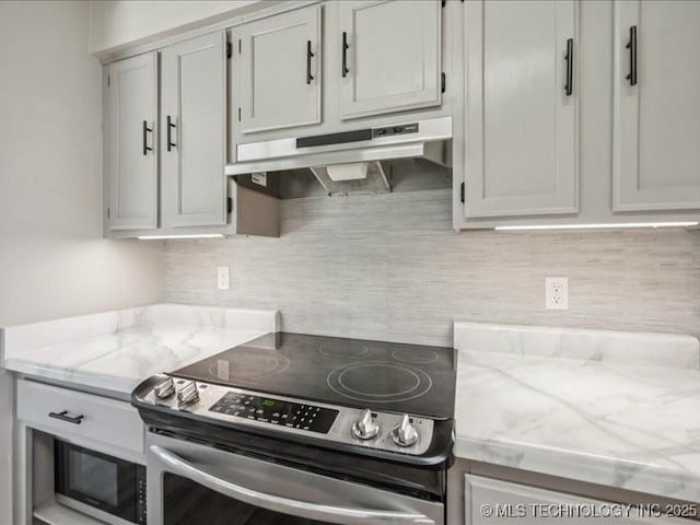 9118 S Florence Ave Unit 9118, Tulsa, OK 74137 - kitchen with stainless steel electric range oven, under cabinet range hood, light stone counters, and tasteful backsplash