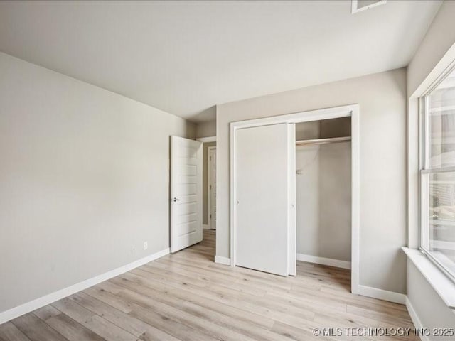 9118 S Florence Ave Unit 9118, Tulsa, OK 74137 - unfurnished bedroom featuring wood finished floors and a closet