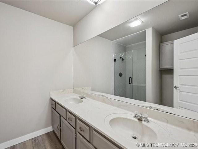 9118 S Florence Ave Unit 9118, Tulsa, OK 74137 - full bathroom featuring double vanity, wood finished floors, and a stall shower
