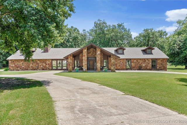 18251 145th W Ave, Sapulpa, OK 74066 - mid-century inspired home with stone siding, a front lawn, curved driveway, and a shingled roof
