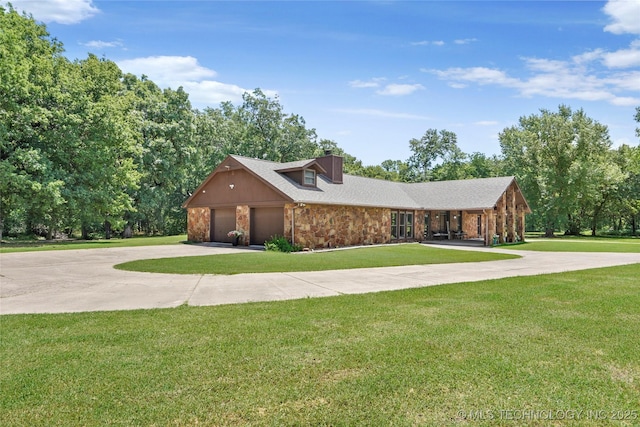 18251 145th W Ave, Sapulpa, OK 74066 - view of front of home featuring concrete driveway, stone siding, a front lawn, and a garage