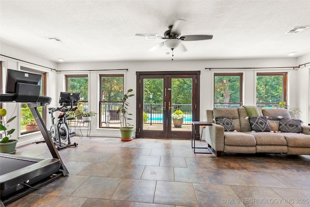18251 145th W Ave, Sapulpa, OK 74066 - workout area with french doors, a ceiling fan, and a textured ceiling