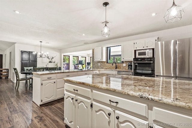 18251 145th W Ave, Sapulpa, OK 74066 - kitchen with appliances with stainless steel finishes, a peninsula, dark wood-type flooring, recessed lighting, and decorative backsplash