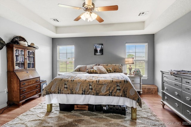 545 E 498th Cir, Pryor, OK 74361 - bedroom with a raised ceiling, multiple windows, and wood finished floors