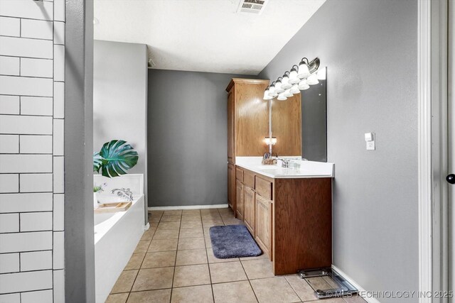 545 E 498th Cir, Pryor, OK 74361 - bathroom with vanity, a garden tub, and tile patterned flooring