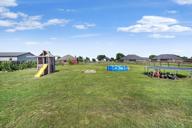 545 E 498th Cir, Pryor, OK 74361 - view of yard with a trampoline and a playground
