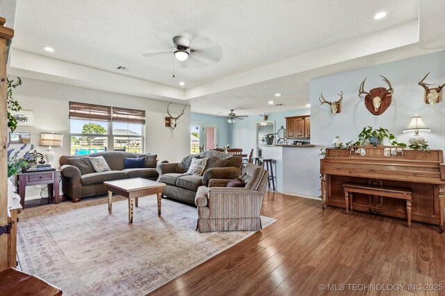 545 E 498th Cir, Pryor, OK 74361 - living area featuring ceiling fan, wood finished floors, a raised ceiling, and recessed lighting
