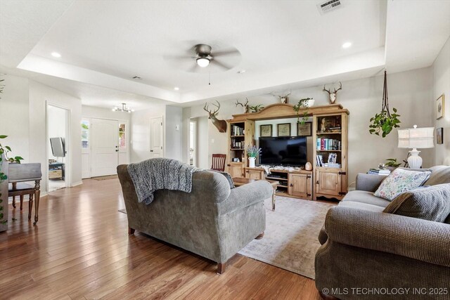 545 E 498th Cir, Pryor, OK 74361 - living room featuring a raised ceiling, wood finished floors, a ceiling fan, and recessed lighting