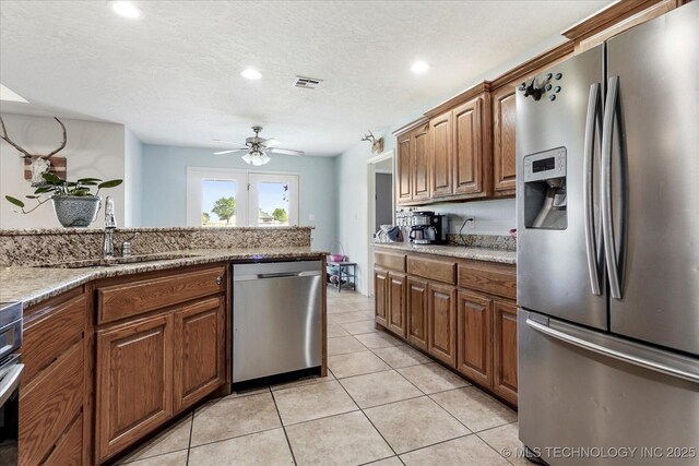 545 E 498th Cir, Pryor, OK 74361 - kitchen with appliances with stainless steel finishes, a ceiling fan, light tile patterned floors, recessed lighting, and brown cabinetry