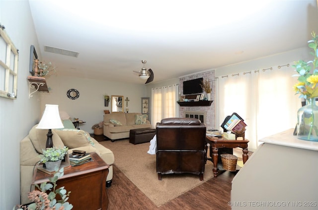 236 W 7th Ave, Bristow, OK 74010 - living room featuring wood finished floors and a brick fireplace